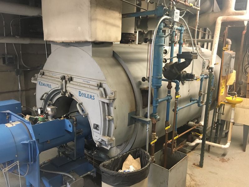 Large Kewanee commercial fire-tube boiler and burner in a mechanical room